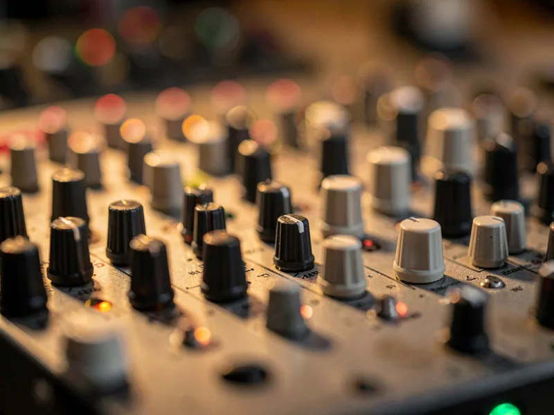 Macro of mixing desk knobs and channel strips, shallow depth of field